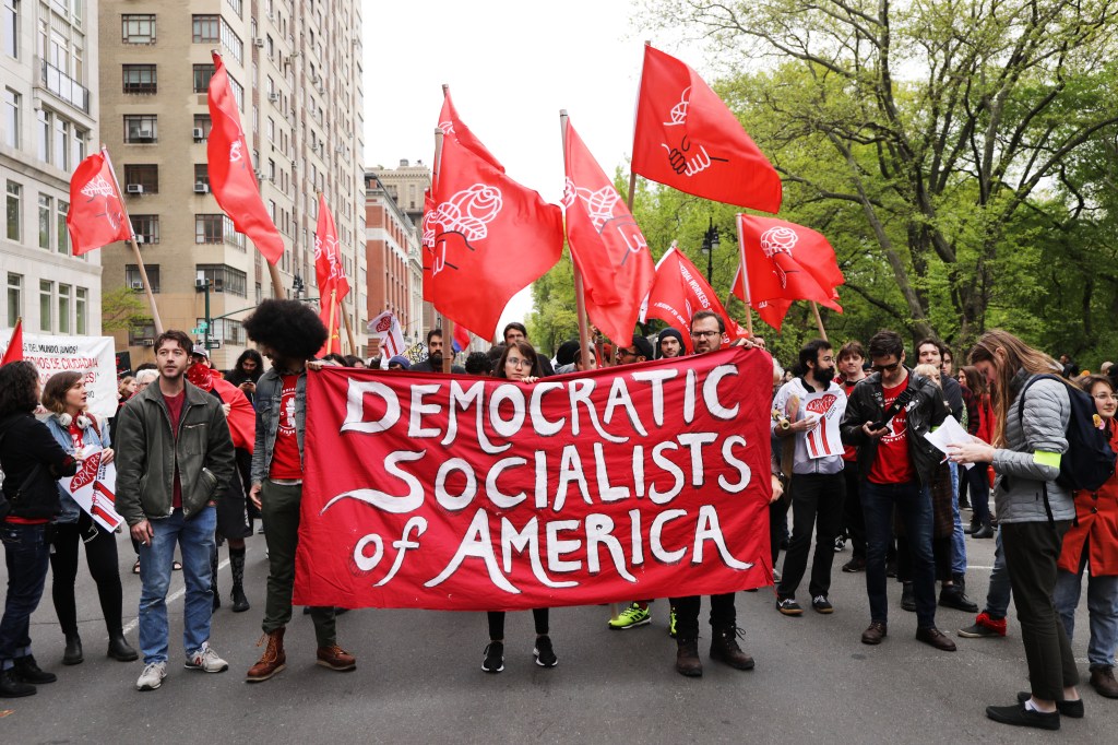 Members of the Democratic Socialists of America gather outside of a Trump-owned building on May Day in New York City. Activists called for immigrants’ rights, better working conditions, and higher salaries.
